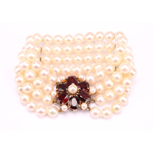 1209 - A garnet and cream cultured pearl bracelet with pink overtones, four strand with two bar dividers wi... 