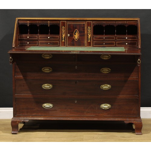 1506 - A George III mahogany bureau, fall front enclosing a fitted interior, the central door inlaid with a... 