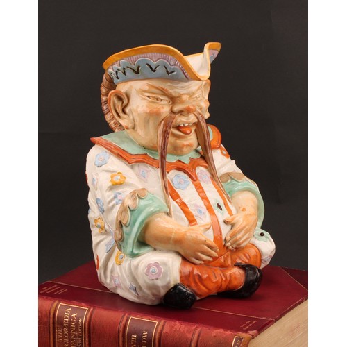 8 - A large Continental majolica character jug, as a seated Chinaman, his plaited hair as the handle, de... 