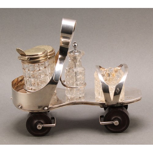 693 - A Victorian E.P.N.S novelty cruet, as a roller skate, turned rosewood wheels, 19cm long, design no. ... 