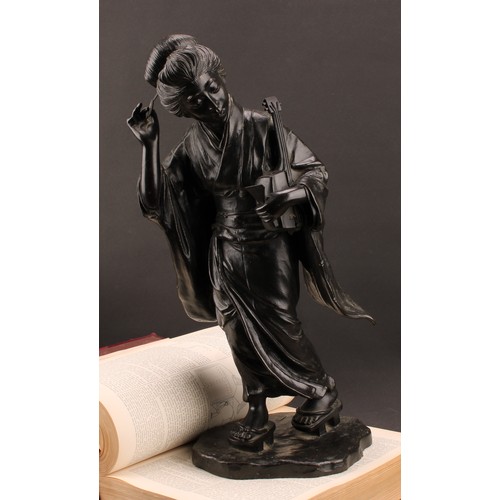 1315 - Japanese School (Meiji period), a large dark patinated bronze, of a geisha, holding a shamisen and a... 