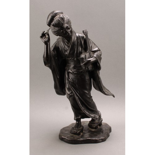 1315 - Japanese School (Meiji period), a large dark patinated bronze, of a geisha, holding a shamisen and a... 