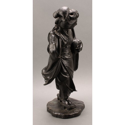 1315 - Japanese School (Meiji period), a large dark patinated bronze, of a geisha, holding a shamisen and a... 