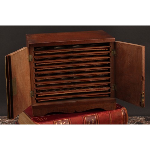 2214 - A 19th century walnut table top coin collector's cabinet, flush top above a pair of doors enclosing ... 