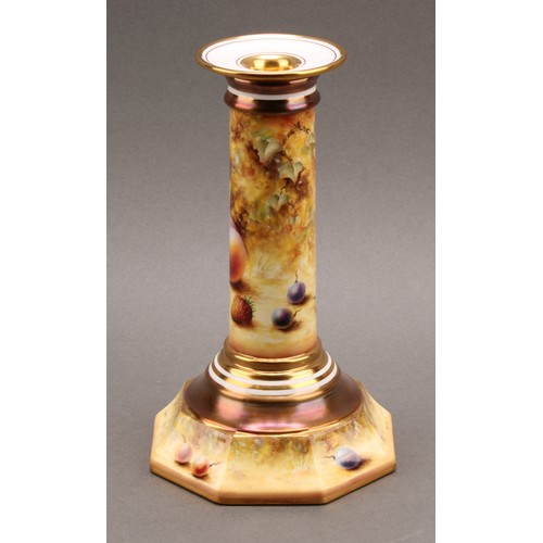 131 - A pair of Royal Worcester candlesticks, painted by Sally Wood, signed, with ripe fruit on a mossy ba... 