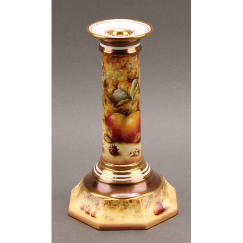 131 - A pair of Royal Worcester candlesticks, painted by Sally Wood, signed, with ripe fruit on a mossy ba... 