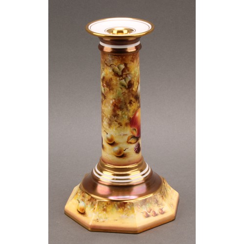 131 - A pair of Royal Worcester candlesticks, painted by Sally Wood, signed, with ripe fruit on a mossy ba... 