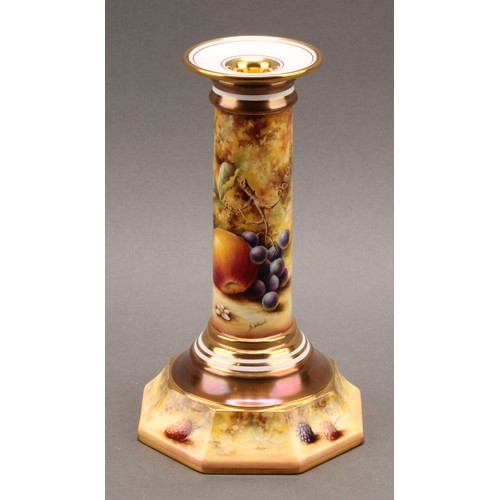 131 - A pair of Royal Worcester candlesticks, painted by Sally Wood, signed, with ripe fruit on a mossy ba... 