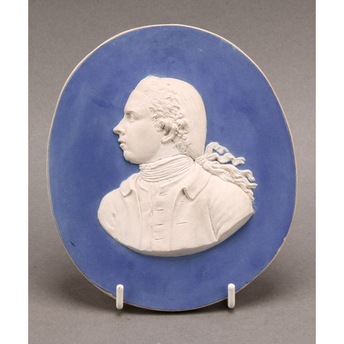 3 - A 19th century jasperware oval portrait plaque, sprigged in white, 14cm x 12.5cm