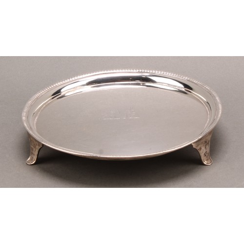 772 - A George III silver circular salver, gadrooned border, crested field, outswept feet, 18cm diam, Thom... 