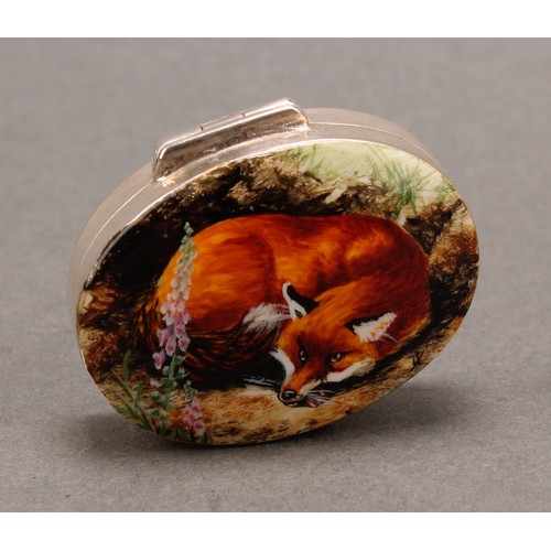 916 - A silver and enamel oval pill box, decorated with a curled up fox, 38mm wide, import marks for Hansf... 