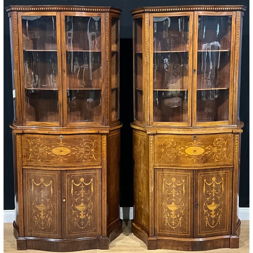 2412 - A pair of Sheraton Revival mahogany and marquetry serpentine secretaire display cabinets, each with ... 