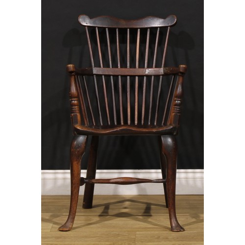 2405 - A 19th century vernacular beech, ash and elm Windsor comb back elbow chair, saddle seat, cabriole fo... 