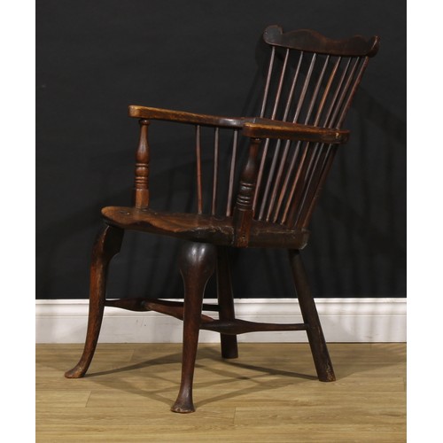 2405 - A 19th century vernacular beech, ash and elm Windsor comb back elbow chair, saddle seat, cabriole fo... 