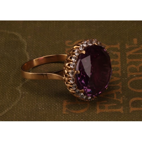 1247 - An 18ct gold synthetic purplish-pink sapphire and cubic zirconia dress ring, the centre sapphire mea... 