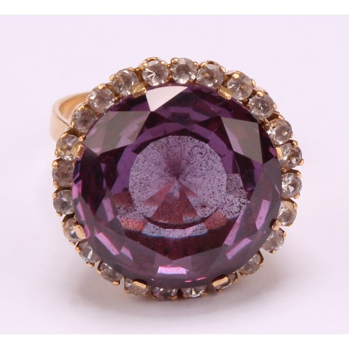 1247 - An 18ct gold synthetic purplish-pink sapphire and cubic zirconia dress ring, the centre sapphire mea... 