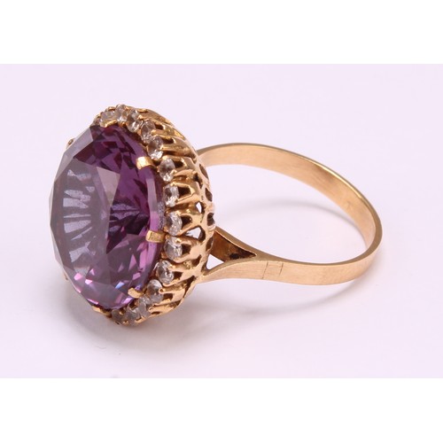 1247 - An 18ct gold synthetic purplish-pink sapphire and cubic zirconia dress ring, the centre sapphire mea... 