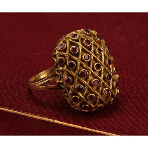 1208 - A domed rectangular shaped ruby ring, crisscrossed cresting set with twenty nine deep pink round bri... 