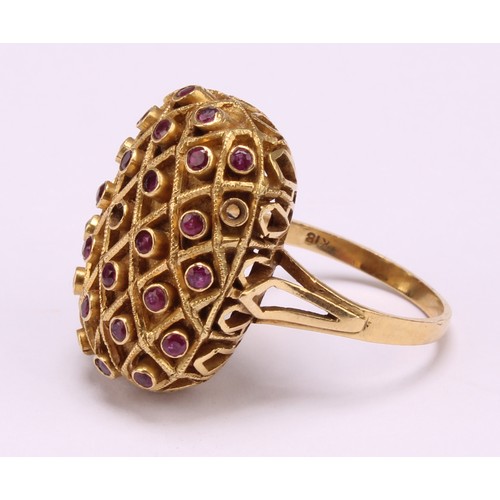 1208 - A domed rectangular shaped ruby ring, crisscrossed cresting set with twenty nine deep pink round bri... 