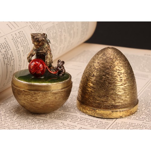 1128 - Stuart Devlin (1931-2018) - an Elizabeth II silver gilt and enamel surprise egg, enclosing a cat and... 