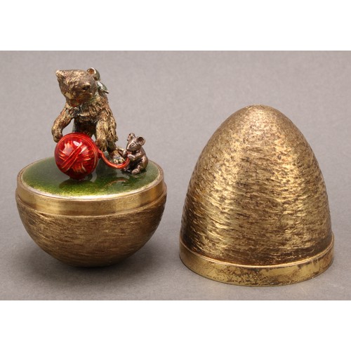 1128 - Stuart Devlin (1931-2018) - an Elizabeth II silver gilt and enamel surprise egg, enclosing a cat and... 