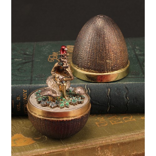 1130 - Stuart Devlin (1931-2018) - an Elizabeth II silver gilt surprise egg, enclosing a pixie on a toadsto... 