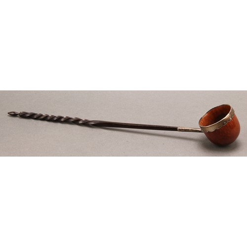 778 - A George III silver mounted coquilla nut toddy ladle, wavy rim, twisted baleen handle, 30cm long ove... 