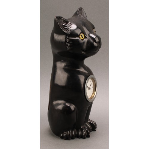 2340 - An early 20th century ebonised novelty timepiece, carved in the Black Forest manner as a seated cat ... 