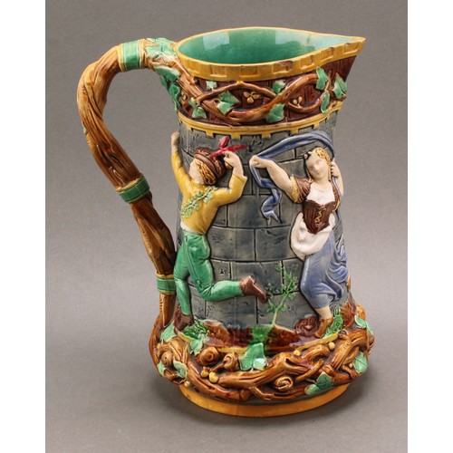 9 - A Minton majolica 'tower' jug, relief moulded with medieval dancers, naturalistic vine handle, 24cm ... 