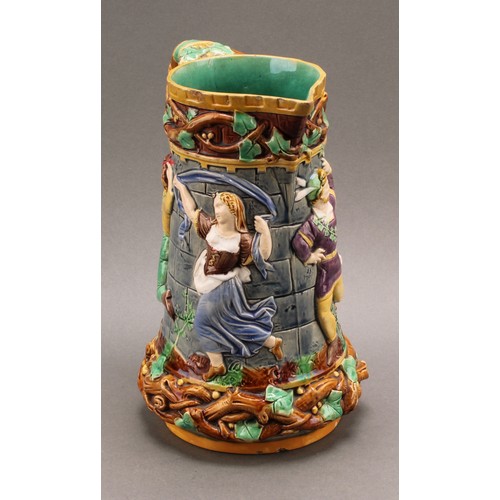 9 - A Minton majolica 'tower' jug, relief moulded with medieval dancers, naturalistic vine handle, 24cm ... 