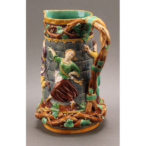 9 - A Minton majolica 'tower' jug, relief moulded with medieval dancers, naturalistic vine handle, 24cm ... 