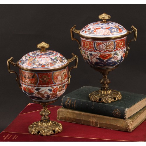 1312 - A pair of 18th century Chinese sucriers and covers, painted in the Imari palette and clobbered in gi... 