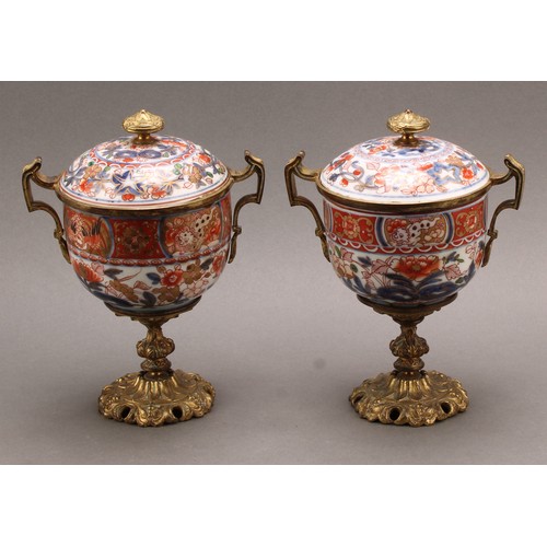 1312 - A pair of 18th century Chinese sucriers and covers, painted in the Imari palette and clobbered in gi... 