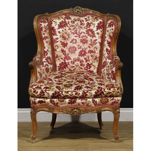 2411 - A pair of Louis XV Revival wing chairs, each with stuffed-over upholstery, squab cushion, cabriole l... 