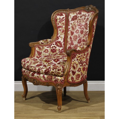 2411 - A pair of Louis XV Revival wing chairs, each with stuffed-over upholstery, squab cushion, cabriole l... 