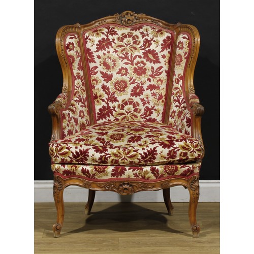 2411 - A pair of Louis XV Revival wing chairs, each with stuffed-over upholstery, squab cushion, cabriole l... 