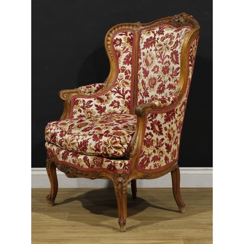 2411 - A pair of Louis XV Revival wing chairs, each with stuffed-over upholstery, squab cushion, cabriole l... 