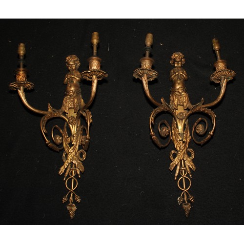 2474 - A pair of 19th century ormolu two-light wall sconces, each cast with a putto herm playing pipes, aca... 