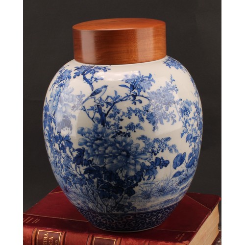 1299 - A Japanese porcelain ovoid ginger jar, painted in tones of underglaze blue with the birds amongst fl... 