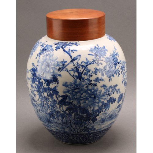 1299 - A Japanese porcelain ovoid ginger jar, painted in tones of underglaze blue with the birds amongst fl... 