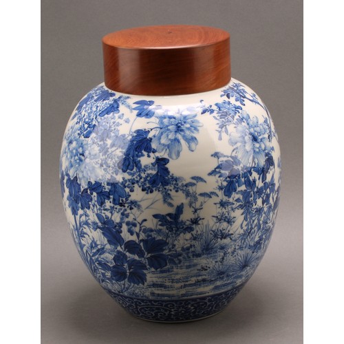 1299 - A Japanese porcelain ovoid ginger jar, painted in tones of underglaze blue with the birds amongst fl... 