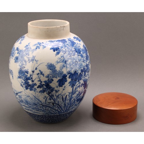 1299 - A Japanese porcelain ovoid ginger jar, painted in tones of underglaze blue with the birds amongst fl... 