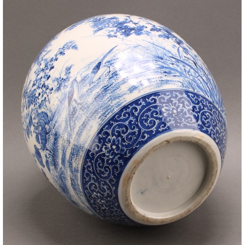 1299 - A Japanese porcelain ovoid ginger jar, painted in tones of underglaze blue with the birds amongst fl... 