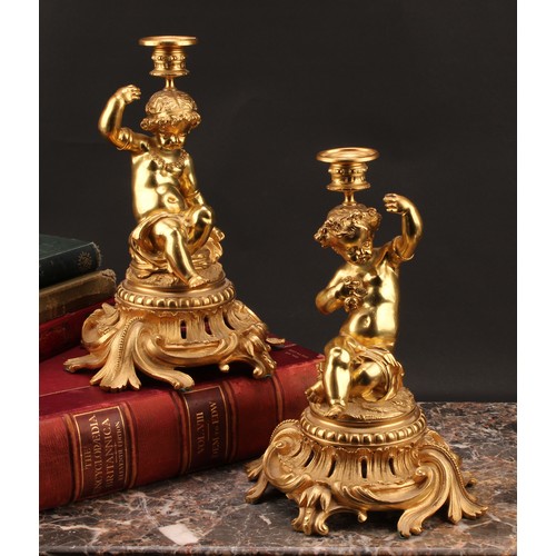 2476 - A pair of French Louis XV style ormolu single light candlesticks of bold proportions, each cast with... 