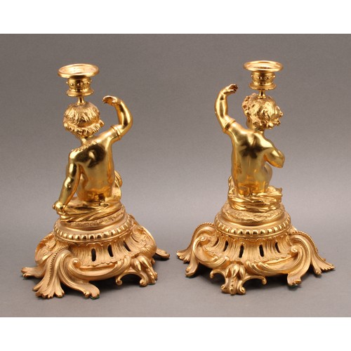 2476 - A pair of French Louis XV style ormolu single light candlesticks of bold proportions, each cast with... 