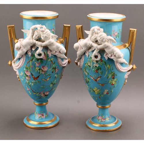 251 - A pair of French porcelain two handled pedestal urnular vases, in the manner of Sevres, painted with... 