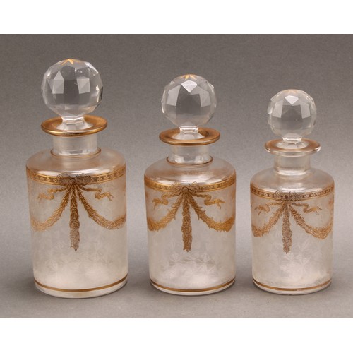 285 - A graduated set of three French glass cologne or toilette water bottles, probably St. Louis, etched ... 