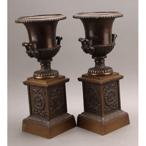 2081 - A pair of 19th century brown patinated bronze campana library urns, in the Grand Tour taste, each ba... 