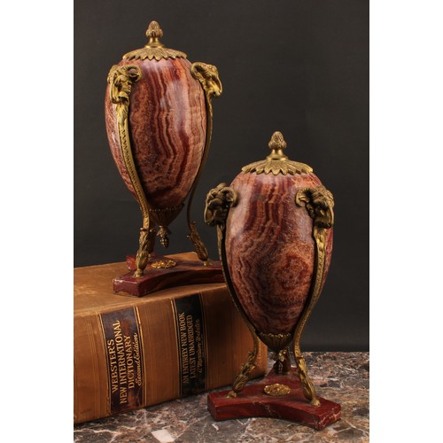 2400 - A pair of Neoclassical gilt bronze mounted alabastro fiorito ovoid urns, the mounts cast as caprine ... 