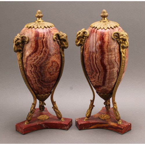 2400 - A pair of Neoclassical gilt bronze mounted alabastro fiorito ovoid urns, the mounts cast as caprine ... 